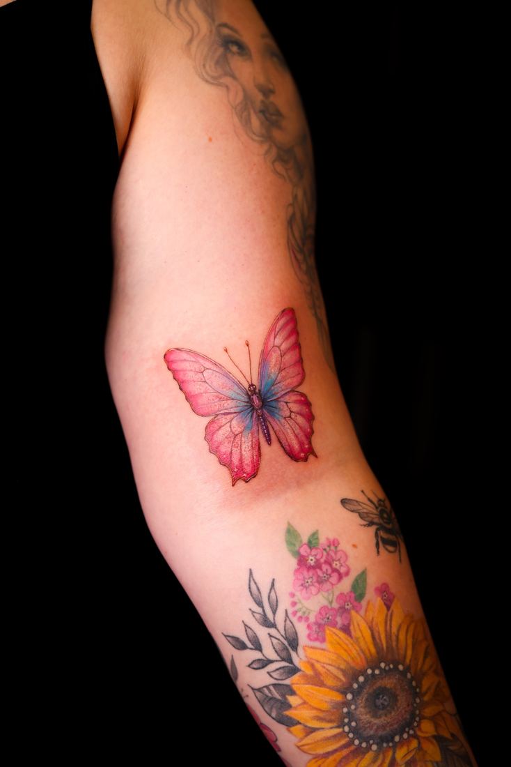 Butterfly and sunflower on the arm