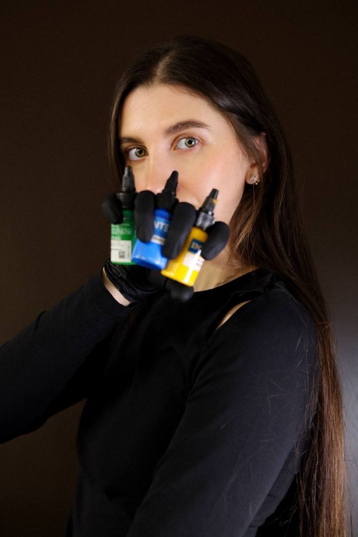 Ladygina holding ink bottles